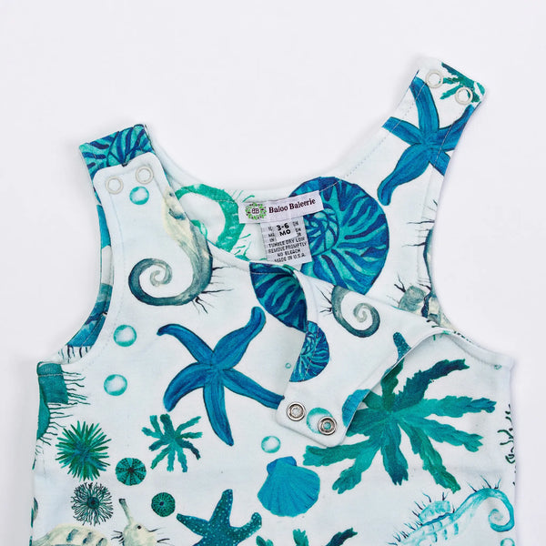 Baloo Baleerie closeup of child's mint romper with turquoise and teal starfish, sea urchin, seahorse repeated design and 2 snap closure on both shoulders with one set unsnapped