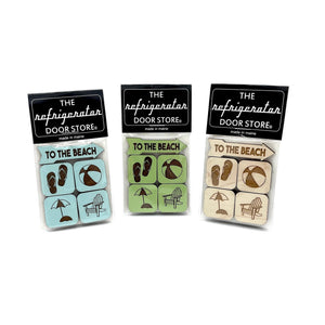 Maine Wooden Magnet Set by 163 Design Company featuring colorful wooden magnets with Maine-themed designs, grouped on a surface.