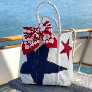 Red nautical bandana by A Wee Maine Artist featuring maritime-inspired design, made of soft fabric for versatile wear.