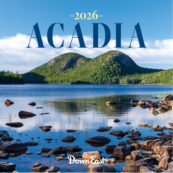 Down East Calendar Acadia Wall Calendar for 2026, featuring scenic images of Acadia National Park, displayed on a wall.