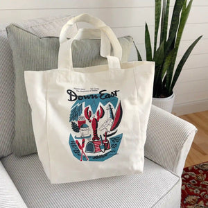 Vintage canvas tote bag by Down East Products with a classic cover design, featuring sturdy handles and a spacious interior.