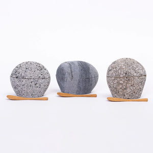 Beach stone salt cellar by Funky Rock Designs featuring a natural, smooth stone lid and ceramic container for salt storage.