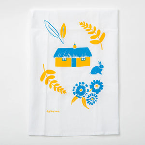 Gray Day Studio yellow house tea towel with a charming house illustration on soft fabric.
