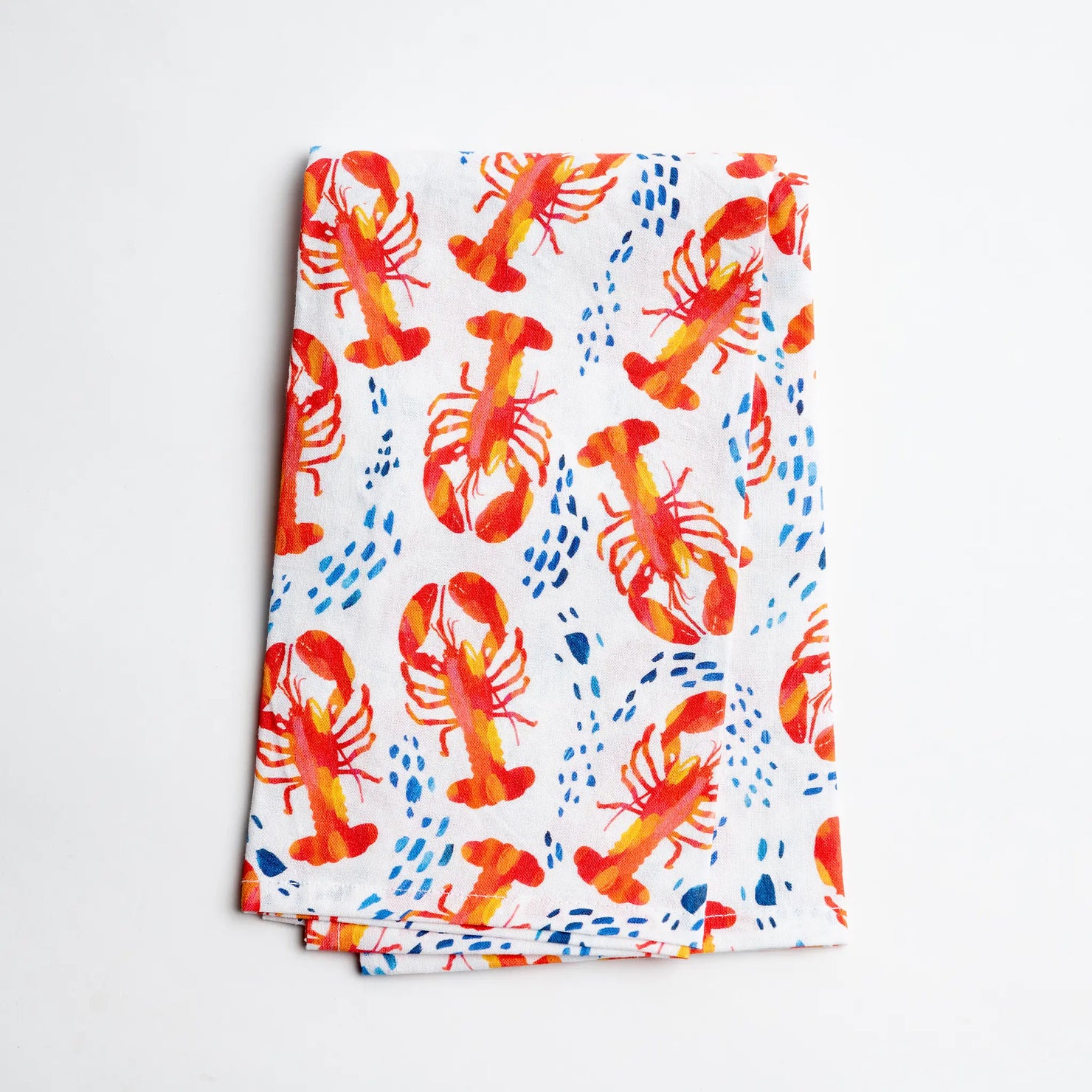 Watercolor tea towel featuring lobsters in the surf, showcasing vibrant red lobsters and ocean waves, by Gert & Co.