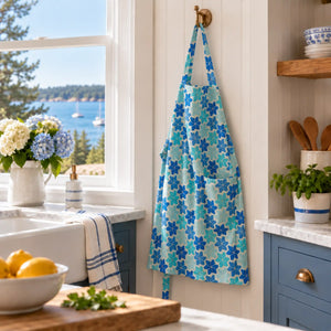 Linen apron by Lola Arts featuring a Maine flowers print, showcasing a soft, natural fabric with adjustable neck straps and waist ties.