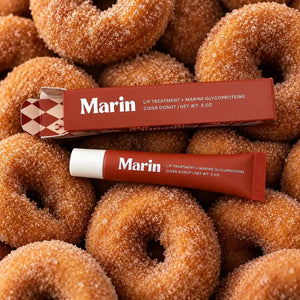 Marin Skincare Cider Donut Lip Treatment tube, close-up of the nourishing lip balm with fruity, cider-inspired flavor on a natural background.