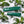 Marin Skincare Mint Lip Treatment tube with fresh mint leaves beside it, showcasing a hydrating lip balm product.