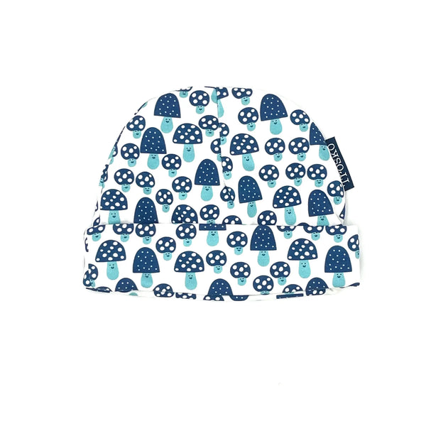 Baby hat with navy mushroom pattern on a white background