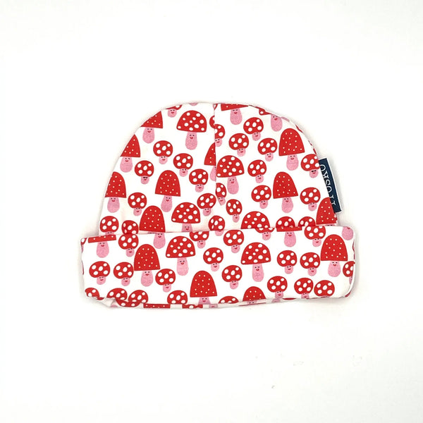 Baby hat with red mushroom pattern on a white background