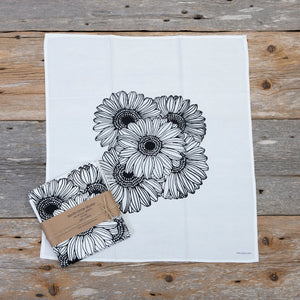 Set of Four + North cloth napkin sets featuring sunflower design, made of soft fabric for elegant table settings.