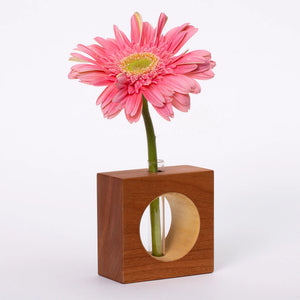 Cherry-colored ceramic bud vase by S.E. Hall Furniture with a sleek, rounded design perfect for small floral arrangements.