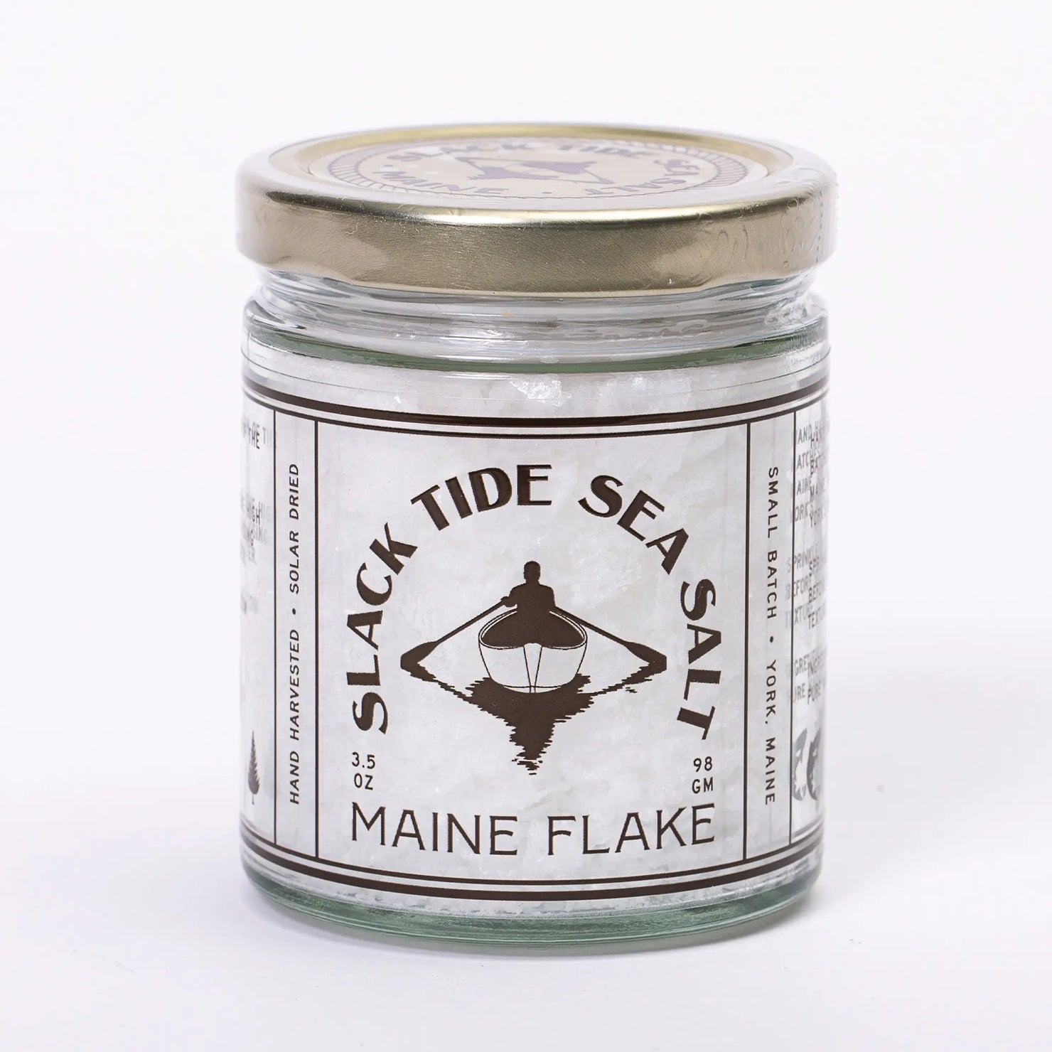 Maine Flake Finishing Sea Salt by Slack Tide Maine in a clear jar, showing delicate flaky salt crystals perfect for finishing dishes.
