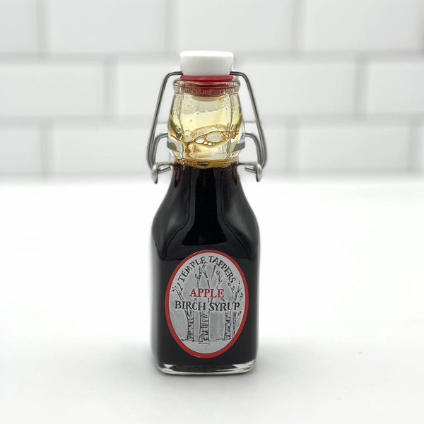 Bottle of Apple Birch Syrup with a white background