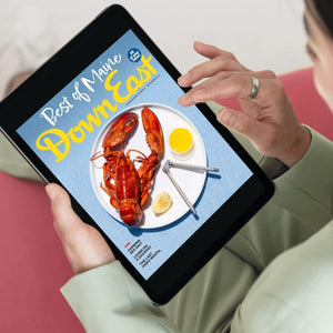 A close-up of a framed Down East Magazine subscription card featuring the magazine's logo and a sample issue cover.