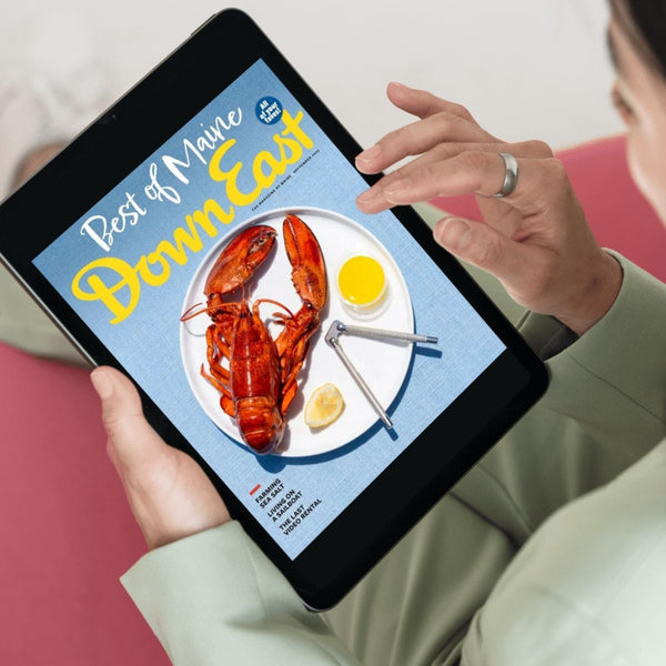 A close-up of a framed Down East Magazine subscription card featuring the magazine's logo and a sample issue cover.