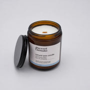 Wayward Chickadee Downeast Dew scented candle in a glass jar with a natural wax finish, showcasing the product without a lid