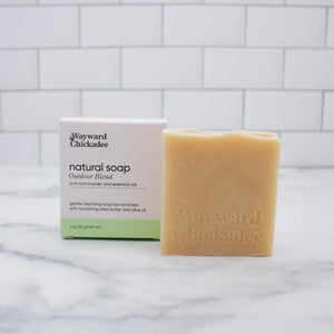 Natural soap bar by Wayward Chickadee with outdoor blend scent, showcasing a rustic, handcrafted appearance and earthy packaging.