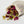 Load image into Gallery viewer, Bee Balm and Nettle closeup of muslin bag of peaceful mind bath tea on its side with contents of dried roses and more spilling out 
