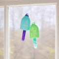 Blue and green glass buoy ornaments by Casco Bay Glassworks, nautical decor with vibrant glass buoy design.