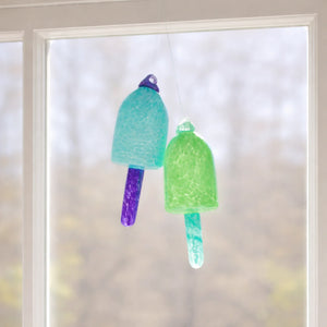 Blue and green glass buoy ornaments by Casco Bay Glassworks, nautical decor with vibrant, colorful glass buoy designs.