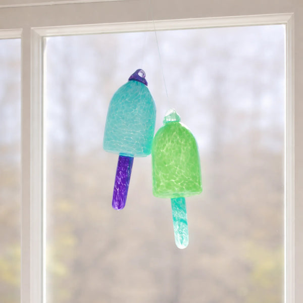 Blue and green glass buoy ornaments by Casco Bay Glassworks, nautical decor with vibrant, colorful glass buoy designs.