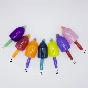 Group of colorful nautical glass buoy ornaments by Casco Bay Glassworks, showcasing vibrant glass floats in a maritime display.