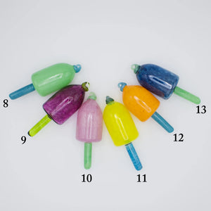 Group of colorful nautical glass buoy ornaments by Casco Bay Glassworks, showcasing vibrant, hand-blown glass decorations.