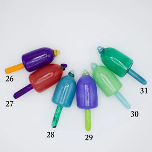 Group of colorful nautical glass buoy ornaments from Casco Bay Glassworks, showcasing vibrant glass craftsmanship and maritime decor.
