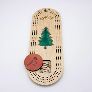 Cast & Carve Pine Tree Epoxy Cribbage Board lid featuring a detailed pine tree design and a smooth, glossy finish.