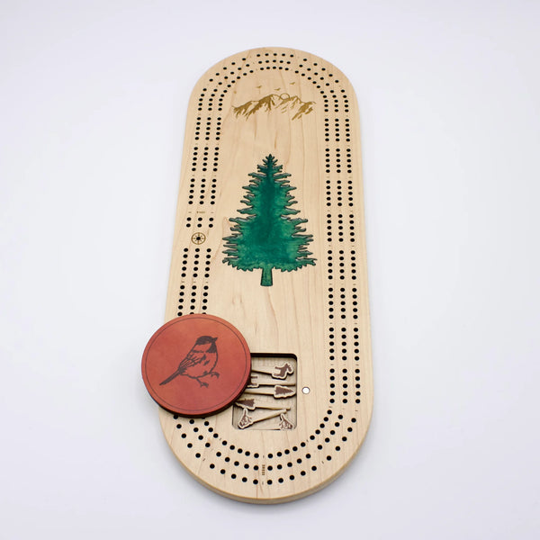 Cast & Carve Pine Tree Epoxy Cribbage Board lid featuring a detailed pine tree design and a smooth, glossy finish.