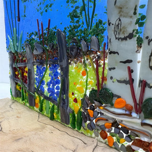 Stained glass art workshop with colorful glass pieces and tools, ideal for creative glass crafting sessions by Down East Adventures.