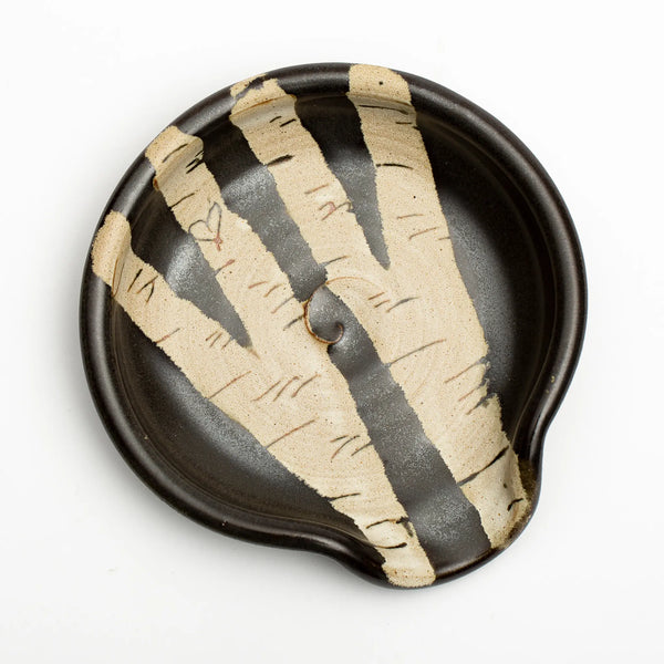 the round birch spoon rest features the black outline of a heart in the left branching birch tree