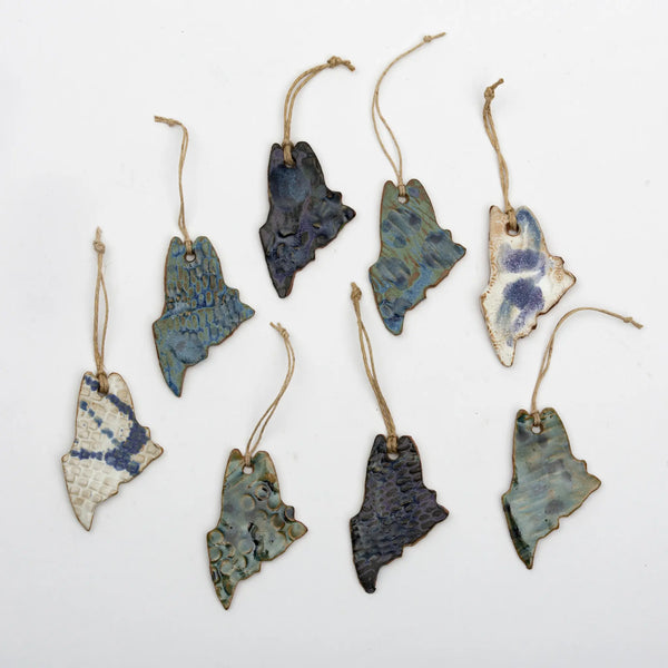 Each Maine stoneware ornament has a unique combination of blue, purple, white, and/or green glazes
