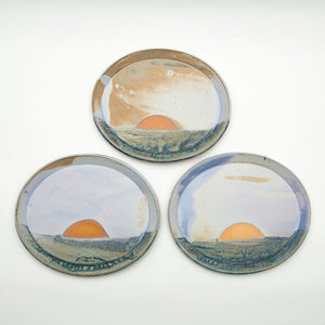 Group of Maine Sunset Platter ceramic dishes by Good Land Pottery with vibrant sunset-inspired glaze and artistic design.