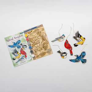 Painted birds ornament kit as it arrives next to five finished, painted examples