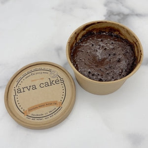 Chocolate peanut butter cake from Jarva Cakes with rich frosting and layered texture, displayed on a white plate.