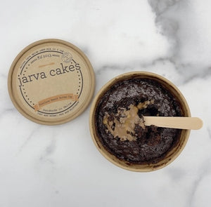 Chocolate peanut butter lava cake by Jarva Cakes with a gooey, melted center, served on a plate with a fork.