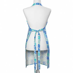Lola Arts linen apron with Maine flower print, showing the back design and adjustable neck strap.