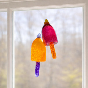 Orange raspberry glass buoy ornament by Casco Bay Glassworks, handcrafted nautical decor with vibrant glass design.