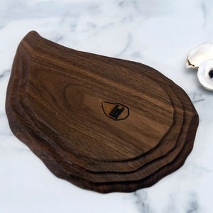 Hand-carved walnut oyster platter by Oyster River Joinery featuring smooth, natural wood finish and organic shape.