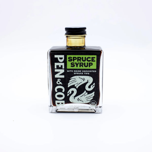 Front view of Pen and Cob Spruce Syrup bottle showing label and green cap, highlighting natural spruce flavor.
