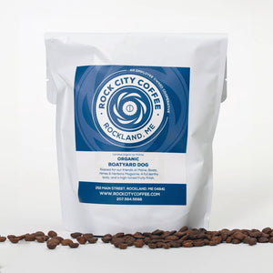 Organic Rock City Coffee Beans in a bag featuring a boatyard dog illustration, showcasing fresh, high-quality coffee beans.