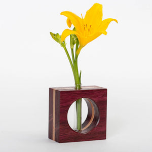 Purpleheart wood bud vase by S.E. Hall Furniture with natural wood grain and smooth, rounded shape.
