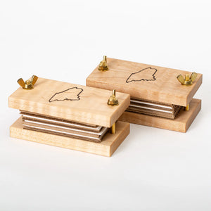 Maple Pocket Flower Press by S.E. Hall Furniture showing metal clamps and pressed flowers inside the compact wooden frame.