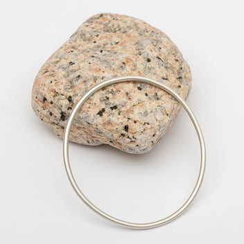 Brushed silver bangle from Sea Salt + Silver featuring a sleek, modern design with a smooth, matte finish.