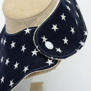 Two Little Beans & Co. baby bib with lobster and star pattern, made of soft fabric for feeding and drool protection.