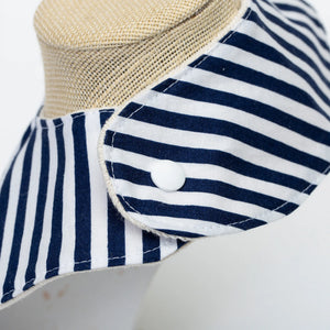 Navy baby bib with anchor pattern from Two Little Beans & Co., featuring soft fabric and adjustable neck closure.
