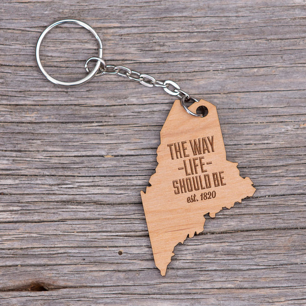 163 Design Company metal keyring with attached wooden shaped  Maine with the words THE WAY LIFE SHOULD BE  est.1820 in the middle