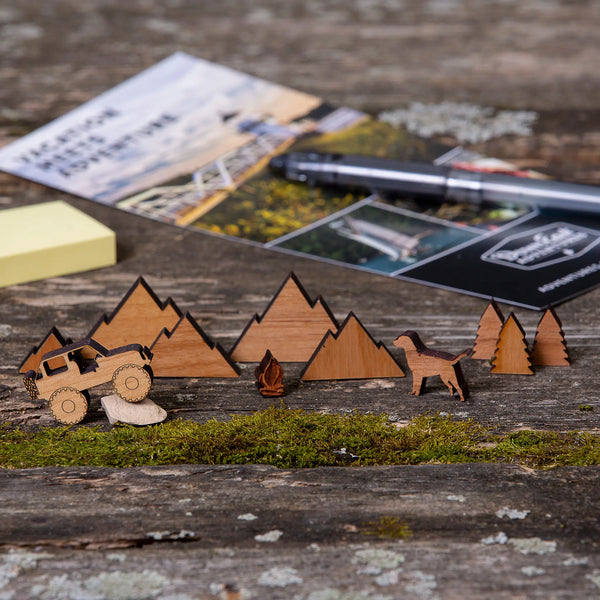 163 Design Company small wooden pieces include Jeep, dog, campfire, mountains, and pine trees