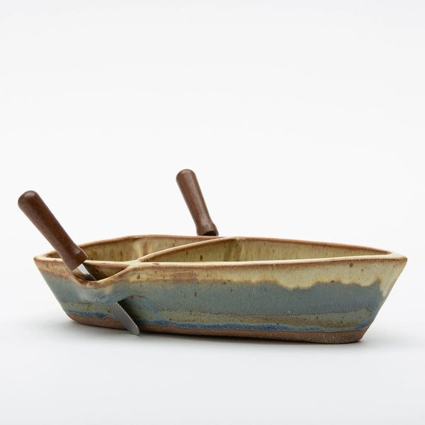 Ash Cove Pottery side view of pottery double dip dinghy dish with two appetizer knives in oar locks